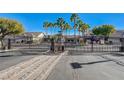 Gated community entrance with palm trees and well-maintained landscaping, ensuring privacy and security at 9271 Mandeville Bay Ave, Las Vegas, NV 89148