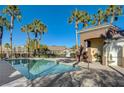Community pool showcasing a pristine pool with a relaxing lounge area and a clear blue sky backdrop at 9271 Mandeville Bay Ave, Las Vegas, NV 89148