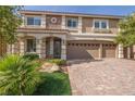 Beautiful two-story home with a well-manicured lawn, three-car garage, and stylish stone accents at 9781 Arcadian Estate Ct, Las Vegas, NV 89141