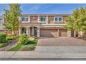 Charming two-story home boasting a three-car garage and meticulously landscaped front yard at 9781 Arcadian Estate Ct, Las Vegas, NV 89141