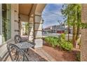 Front porch featuring decorative hanging lanterns and wrought iron furniture at 9781 Arcadian Estate Ct, Las Vegas, NV 89141