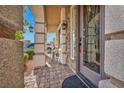 Covered front porch with charming stone pillars and decorative hanging lanterns, plus furniture at 9781 Arcadian Estate Ct, Las Vegas, NV 89141
