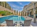 Inviting pool with blue tile and well-manicured landscaping, perfect for outdoor enjoyment at 9781 Arcadian Estate Ct, Las Vegas, NV 89141
