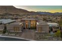 Beautiful contemporary home with manicured landscaping, brick paved driveway, and mountain views at 10096 Amethyst Hills St, Las Vegas, NV 89148
