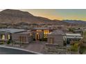 Beautiful contemporary home with brick paved driveway, professionally landscaped yard, and mountain views at 10096 Amethyst Hills St, Las Vegas, NV 89148