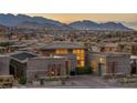 Contemporary home showcasing stylish architecture, lush landscaping, and breathtaking mountain views at 10096 Amethyst Hills St, Las Vegas, NV 89148