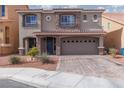 Charming two-story home with a well-maintained front yard and a two car garage at 10145 Arbor Brook Ct, Las Vegas, NV 89141