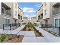 Townhouses are surrounding a manicured courtyard with walkways and landscaping at 12305 Crimson Horizon Rd # 4, Las Vegas, NV 89183
