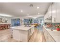 Open-concept kitchen with stainless steel appliances, granite countertops, and an eat-in island at 12356 Grey Dunes Ave, Las Vegas, NV 89138