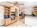 Spacious kitchen featuring stainless steel appliances, custom cabinets, granite countertops, and tile flooring at 1561 Doran Dr, Las Vegas, NV 89123
