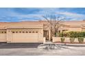 A well-maintained single-story house with tile roof, desert landscaping, and attached garage at 213 N Cimarron Rd, Las Vegas, NV 89145