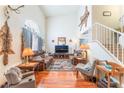 Inviting living room featuring high ceilings, hardwood floors, and a cozy seating area with leather sofas at 2245 Saint Paul Way, Las Vegas, NV 89104