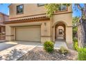 Arched entryway and desert landscaping add charm to this two-story home at 2653 Rimbaud St, Henderson, NV 89044