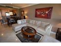 Cozy living room featuring an open layout with cream sectional sofa, glass coffee table and open to dining area at 270 E Flamingo Rd # 319, Las Vegas, NV 89169