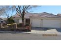 Charming single-story home featuring a terracotta tile roof, two-car garage, and a well-maintained front yard at 3805 Vidalia Ave, North Las Vegas, NV 89031