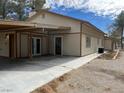 Side view of the home's exterior featuring a long driveway and multiple entrances at 4021 Jesse St, Pahrump, NV 89048