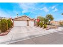 Single story home with a wide driveway, well-kept bushes, and two-car garage at 4318 Red Blanket Rd, North Las Vegas, NV 89032