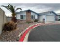 View of the single-story home's exterior, showcasing the yard and desert landscaping at 4712 Primavera St, Las Vegas, NV 89122