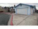 View of the home's side and two-car garage, showcasing its well-maintained exterior at 4712 Primavera St, Las Vegas, NV 89122