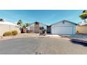 Well-maintained home with stone facade, palm tree, and a two-car garage at 4712 Primavera St, Las Vegas, NV 89122