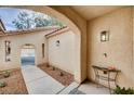 Side entryway featuring an arched entrance and a well-maintained walkway to the front door at 5453 Brass Hills Ct, Las Vegas, NV 89122