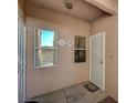Close up of unit entryway with security doors and two windows at 5751 E Hacienda Ave # 172, Las Vegas, NV 89122