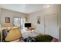 Living room features sliding glass doors, a television and lots of light at 5751 E Hacienda Ave # 172, Las Vegas, NV 89122