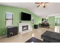 Spacious living room featuring a fireplace, open layout, tile floors, and a view to the kitchen at 5900 Tippin Dr, Las Vegas, NV 89130