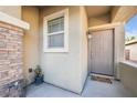 Cozy front entryway with a charming welcome mat and stone accents on the column at 6112 Wheat Penny Ave, Las Vegas, NV 89122