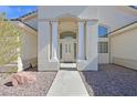 Inviting home entrance with grand columns, desert landscaping and elegant details at 6120 Farm Rd, Las Vegas, NV 89131