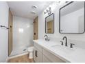 Modern bathroom featuring double sink vanity, contemporary fixtures, and walk-in shower with tile surround at 617 Carpenter Dr, Las Vegas, NV 89107