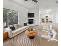 Bright living room featuring a fireplace, large window, and modern decor at 6701 Squaw Mountain Dr # 201, Las Vegas, NV 89130