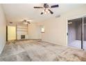 Living room with built-in shelves, bright light, and a sliding glass door to the patio at 6868 Sky Pointe Dr # 1087, Las Vegas, NV 89131
