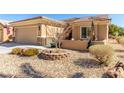 Single-story house showcasing desert landscaping and a partially-covered front patio at 7640 Fieldfare Dr, North Las Vegas, NV 89084