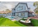 Pool and jacuzzi with lounge chairs on an expansive manicured lawn at 8625 Scarsdale Dr, Las Vegas, NV 89117