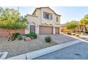 Exterior shot of a two-story stucco home with two-car garage, drought-tolerant landscaping, and blue shutters at 9085 Bridal Creek Ave, Las Vegas, NV 89178