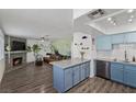 Open floorplan with a fireplace, leather couch, and a kitchen island with seating at 917 Boulder Springs Dr # 202, Las Vegas, NV 89128