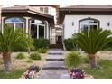 A grand entrance with stone walkway, manicured plants, and an iron gate at 9325 Canyon Classic Dr, Las Vegas, NV 89144