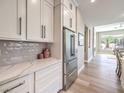 Bright kitchen view of stainless steel refrigerator and subway tile backsplash at 11 Canoa Hills Dr, Henderson, NV 89052