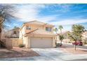 Attractive two-story house with a tile roof, desert landscaping, and a two car garage at 1653 Sun Canyon Ct, Las Vegas, NV 89128