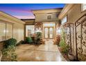 Inviting entrance adorned with stone accents and a decorative wrought iron gate at 2062 Dipinto Ave, Henderson, NV 89052