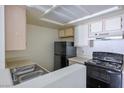Efficient kitchen equipped with a black refrigerator and stove against light countertops at 3550 Bay Sands Dr # 2027, Laughlin, NV 89029