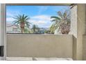 Balcony view with palm trees, screen and blue skies at 3933 Lazy Pine St # 204, Las Vegas, NV 89108