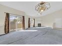 Bright living room featuring a fireplace, sliding glass door and contemporary light fixture at 3933 Lazy Pine St # 204, Las Vegas, NV 89108
