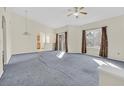 Spacious living room with neutral carpet, lots of light and access to the balcony at 3933 Lazy Pine St # 204, Las Vegas, NV 89108