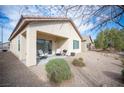 Private backyard featuring a covered patio and low-maintenance gravel landscaping at 5863 Corbin Ave, Las Vegas, NV 89122