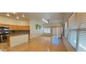 Bright living space open to the kitchen featuring hardwood floors, ample lighting, and stainless steel appliances at 7858 Nookfield Dr, Las Vegas, NV 89147