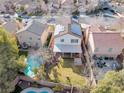 Aerial view of backyard featuring a pool, patio, and well-maintained lawn in a residential neighborhood at 9836 La Vid Ct, Las Vegas, NV 89117