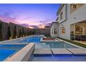 An exterior view of the swimming pool and spa showcasing a seamless transition to the backyard patio at 11991 Rockview Point St, Las Vegas, NV 89138