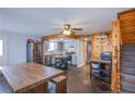 Bright kitchen features stainless appliances, gray cabinetry, and a rustic wood dining table at 1912 Margarita Ave, Henderson, NV 89011